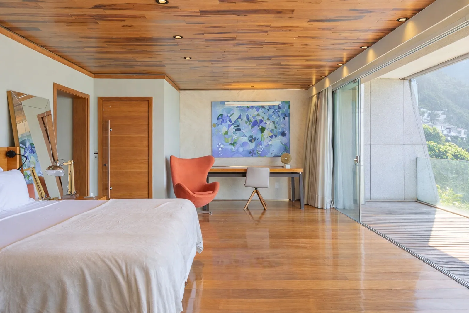 Dormitorio con escritorio y butaca, techo de madera arriba